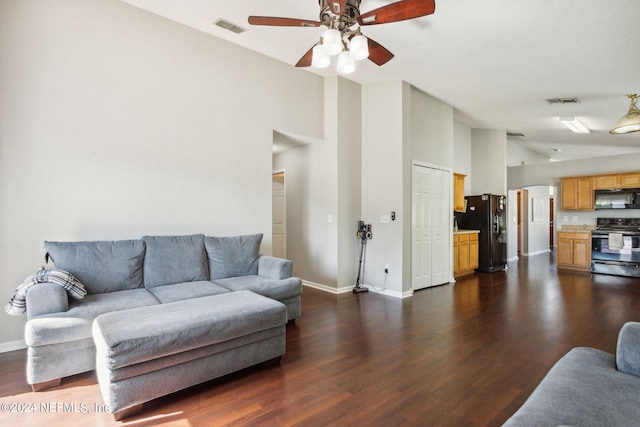 living room featuring dark hardwood / wood-style flooring, high vaulted ceiling, and ceiling fan