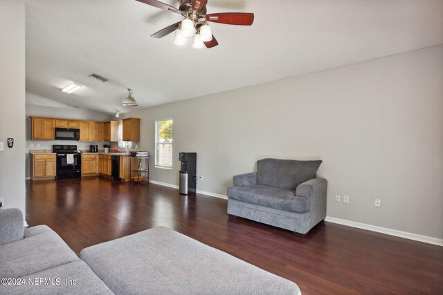 living room with dark hardwood / wood-style floors, ceiling fan, and lofted ceiling