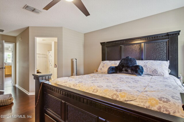 bedroom featuring dark hardwood / wood-style floors, a textured ceiling, and ceiling fan