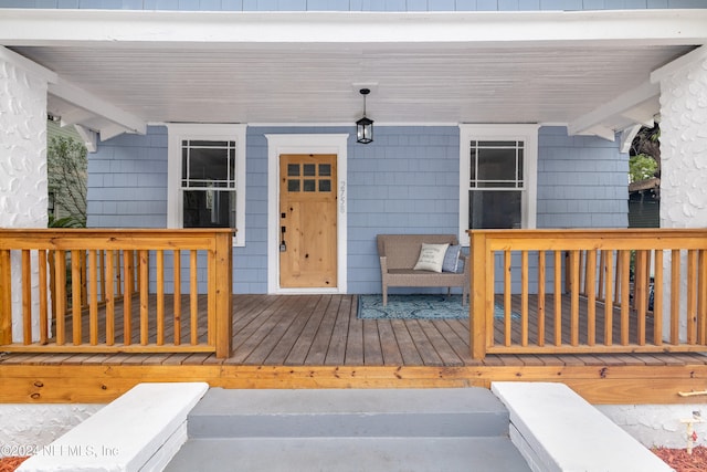 property entrance featuring a wooden deck