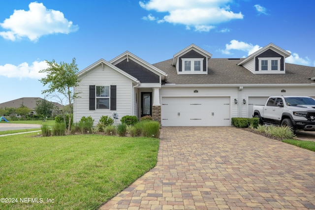 view of front of home featuring a garage and a front yard