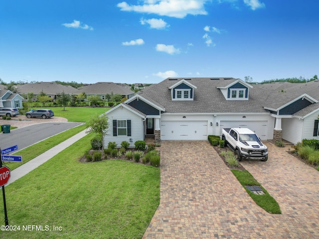 view of front of home with a garage and a front lawn