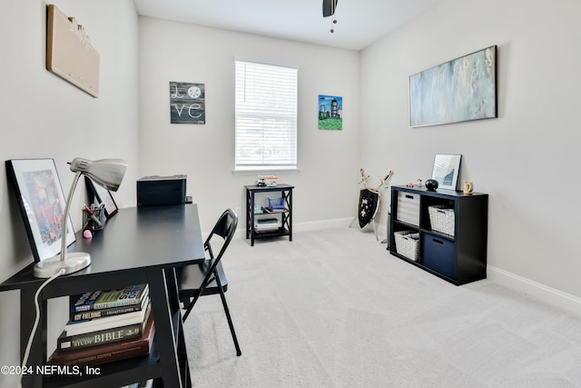 carpeted office space with ceiling fan