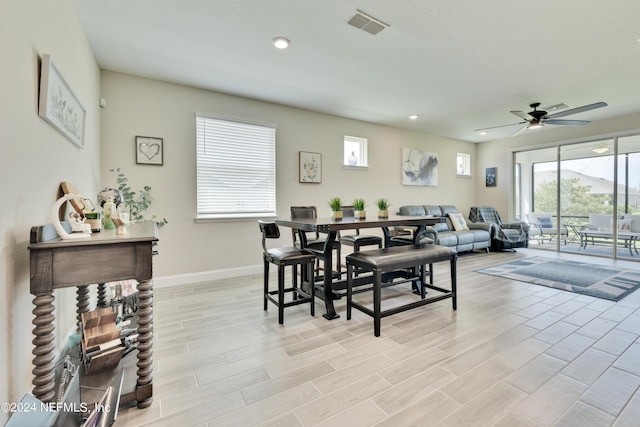 dining area with ceiling fan and light hardwood / wood-style floors