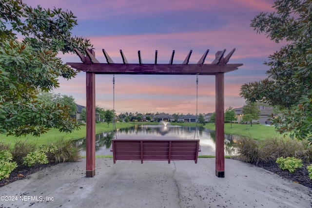 view of community with a water view and a lawn