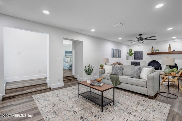 living room featuring ceiling fan and light hardwood / wood-style floors