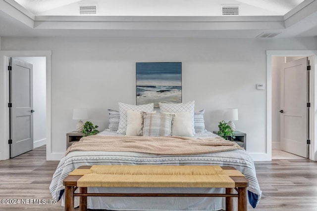 bedroom with hardwood / wood-style flooring