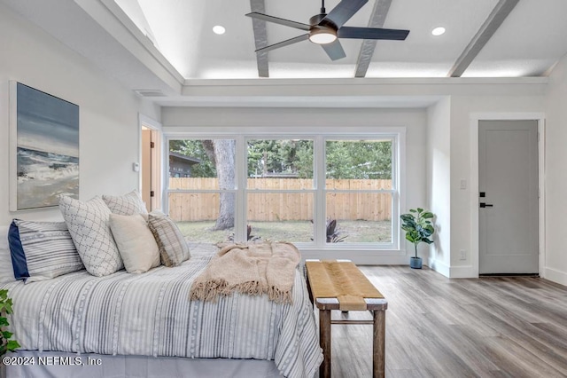 bedroom featuring ceiling fan, wood-type flooring, and multiple windows