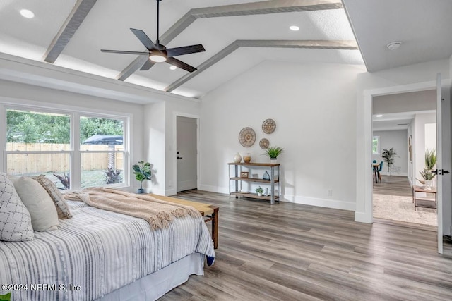 bedroom with hardwood / wood-style floors, ceiling fan, and vaulted ceiling with beams