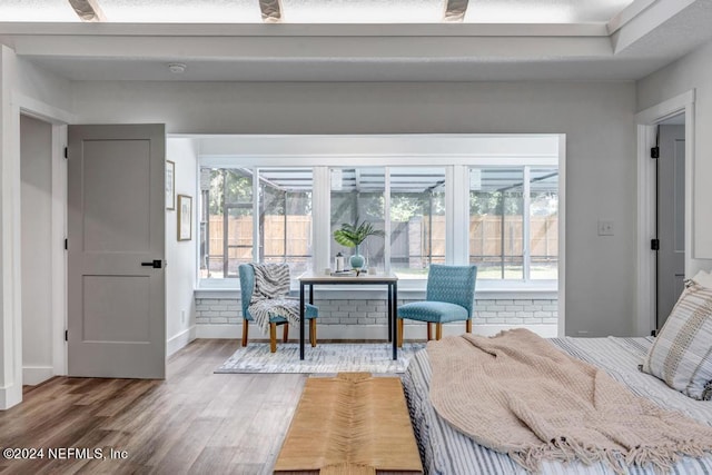 interior space with ceiling fan, wood-type flooring, and multiple windows