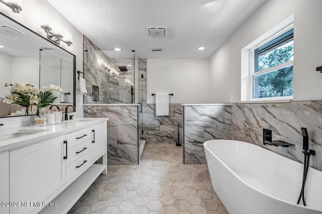 bathroom featuring vanity, separate shower and tub, tile walls, and tile patterned floors