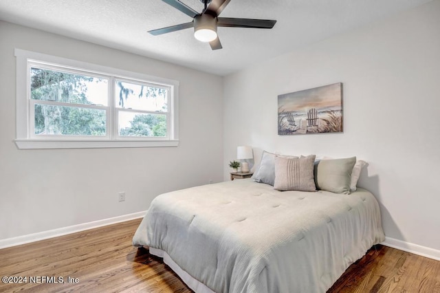 bedroom with wood-type flooring and ceiling fan