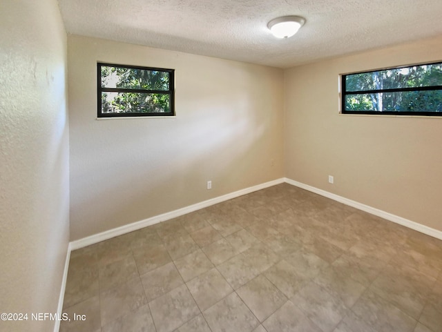 empty room featuring a textured ceiling