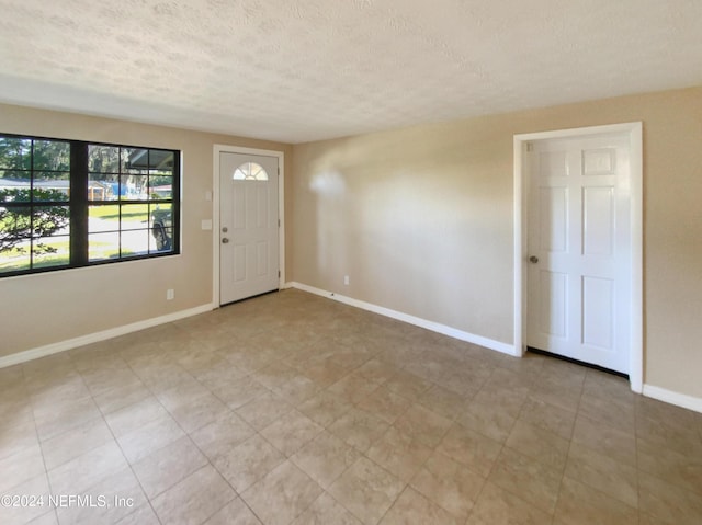 entrance foyer featuring a textured ceiling