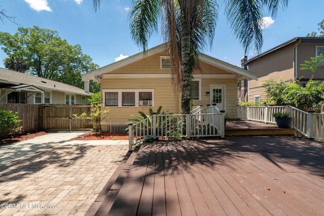 back of house featuring a deck and a patio area