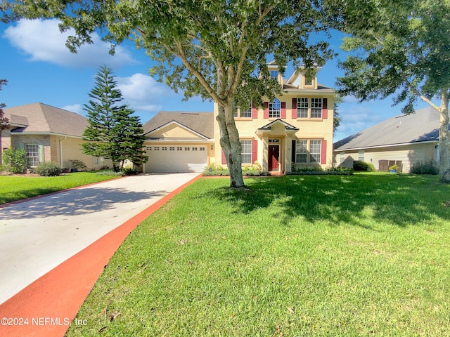 view of front of property with a garage and a front yard