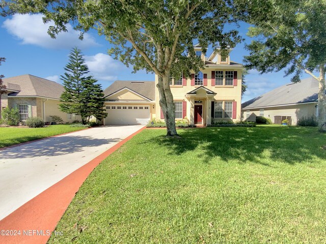 view of front of home with a garage and a front lawn