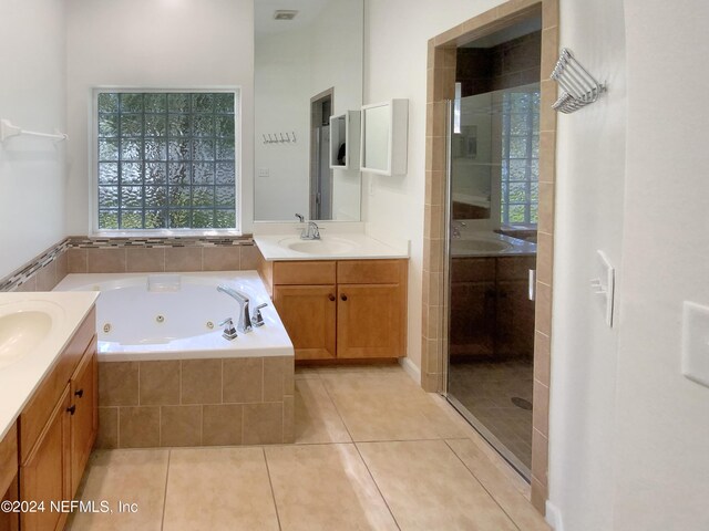 bathroom with vanity, tile patterned floors, and shower with separate bathtub