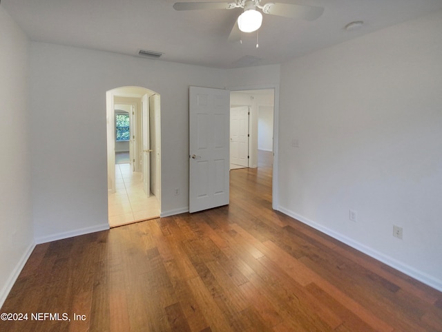 spare room with light wood-type flooring and ceiling fan