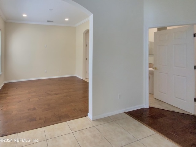 unfurnished room featuring crown molding and light tile patterned floors