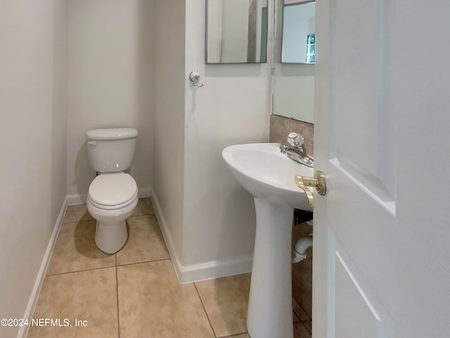 bathroom with tile patterned flooring and toilet