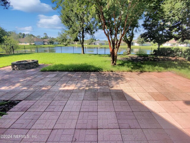 view of patio / terrace with a water view and an outdoor fire pit