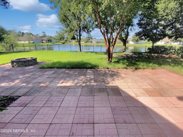 view of patio / terrace featuring a water view and an outdoor fire pit