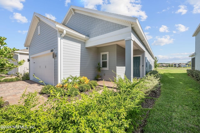 view of home's exterior featuring a yard and a garage