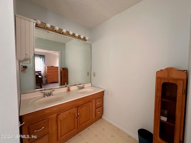 bathroom with a textured ceiling and vanity