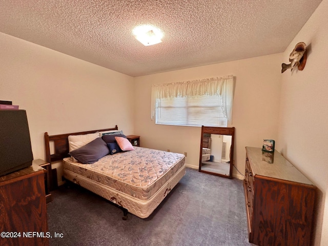 carpeted bedroom featuring a textured ceiling