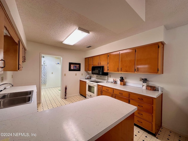 kitchen featuring sink, a textured ceiling, and electric stove