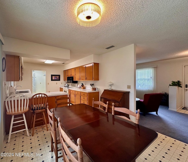 dining area featuring a textured ceiling