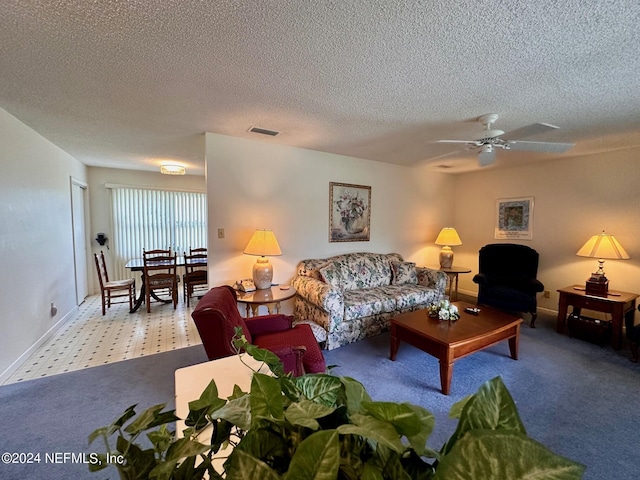 carpeted living room with a textured ceiling and ceiling fan