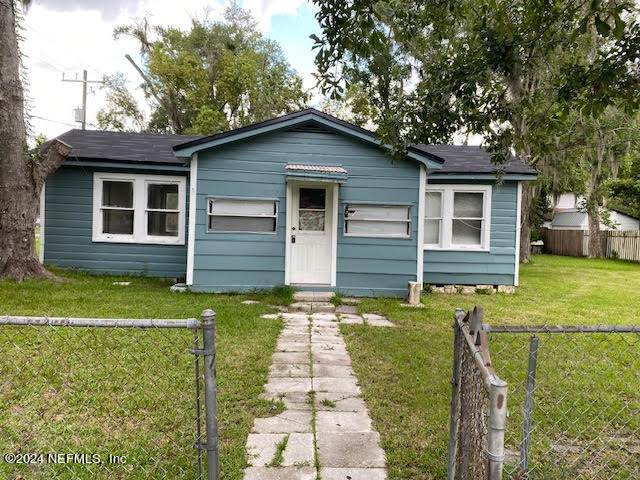 bungalow-style home with a front lawn