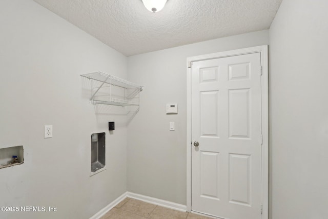 washroom with laundry area, light tile patterned floors, baseboards, a textured ceiling, and washer hookup