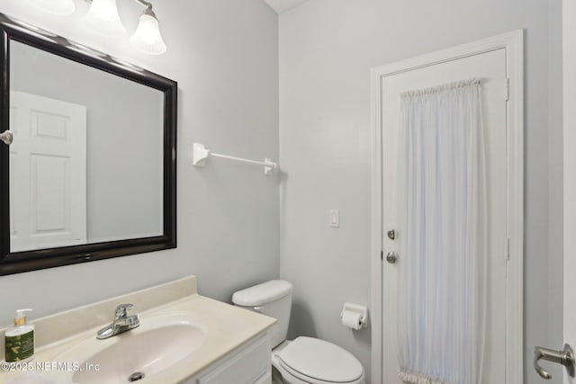 bathroom with vanity and toilet