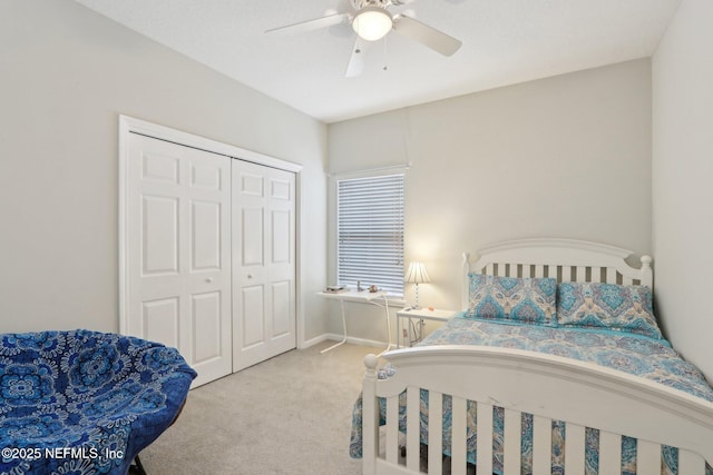 bedroom featuring baseboards, a closet, a ceiling fan, and light colored carpet