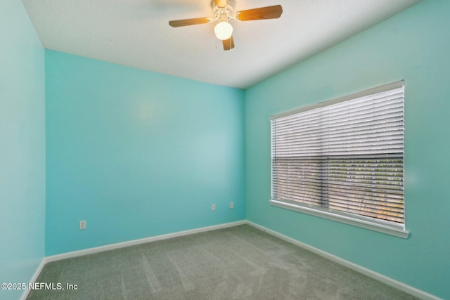 empty room featuring carpet floors, baseboards, and a ceiling fan