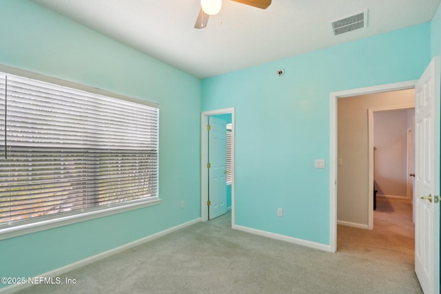 unfurnished bedroom with light carpet, baseboards, and visible vents