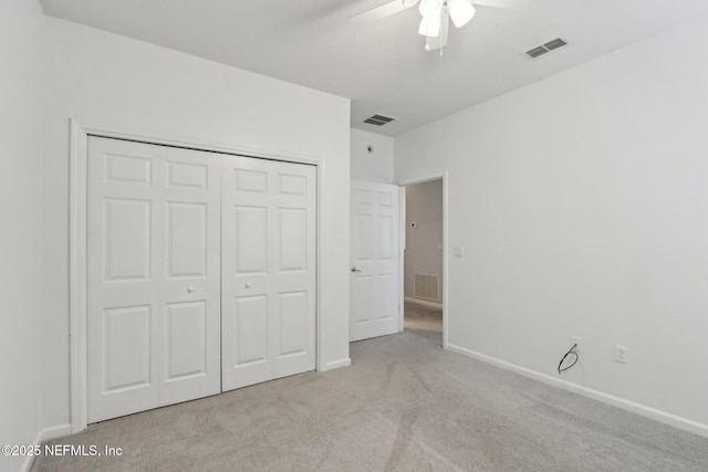 unfurnished bedroom featuring a closet, visible vents, light carpet, and baseboards