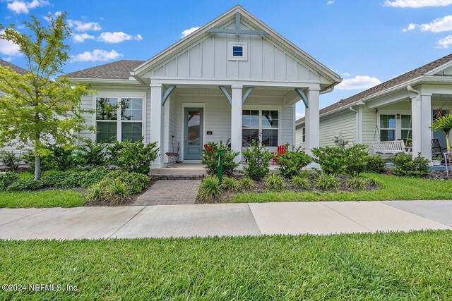 view of front of property with a porch and a front yard