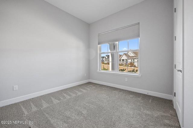 empty room with vaulted ceiling and carpet floors