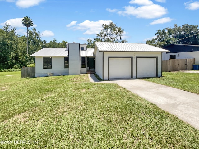 view of front of home with a garage and a front lawn