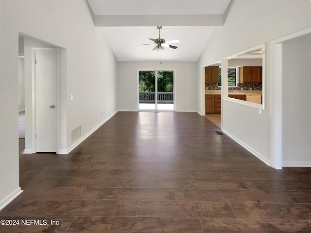 unfurnished living room featuring lofted ceiling with beams, dark hardwood / wood-style floors, and ceiling fan