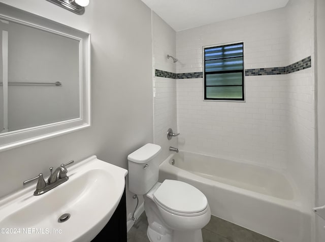 full bathroom with vanity, tiled shower / bath, tile patterned floors, and toilet