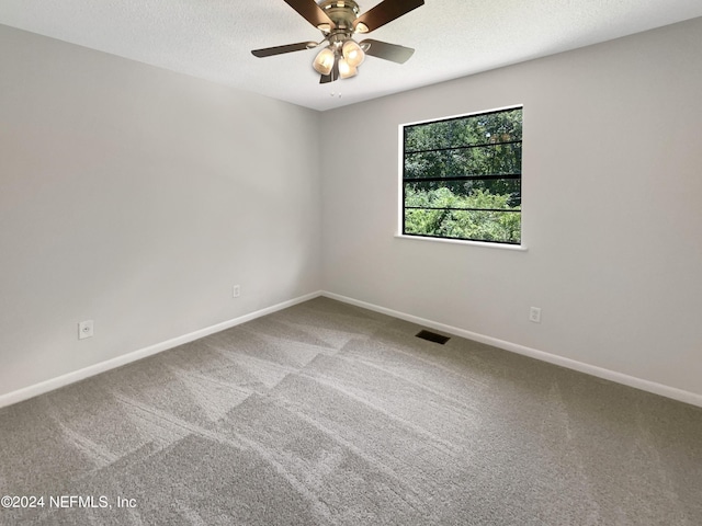 unfurnished room featuring ceiling fan, carpet flooring, and a textured ceiling