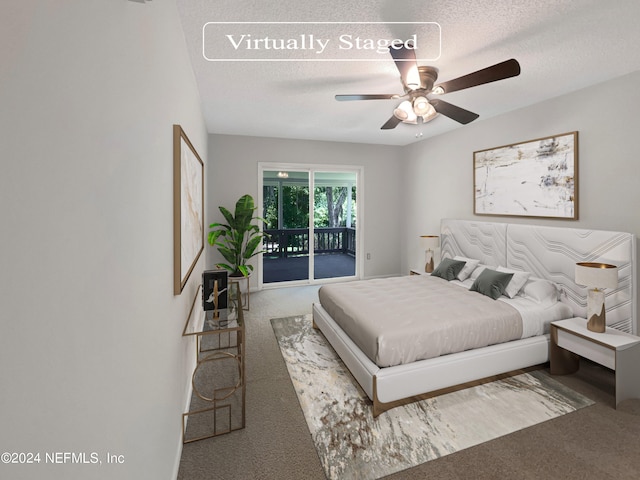 carpeted bedroom featuring access to exterior, a textured ceiling, and ceiling fan