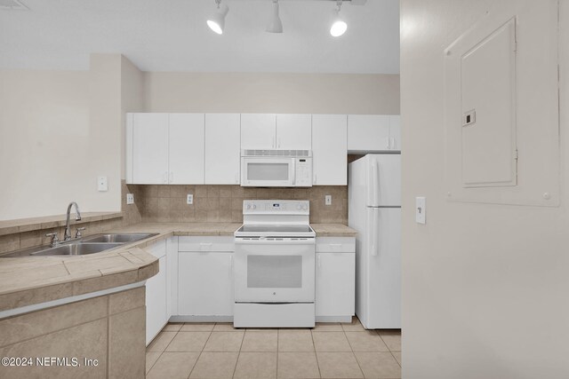 kitchen featuring track lighting, sink, white appliances, and white cabinets