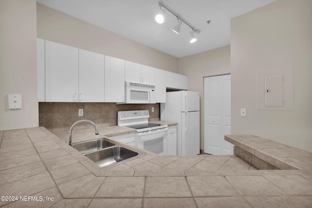 kitchen with white cabinetry, decorative backsplash, white appliances, sink, and track lighting