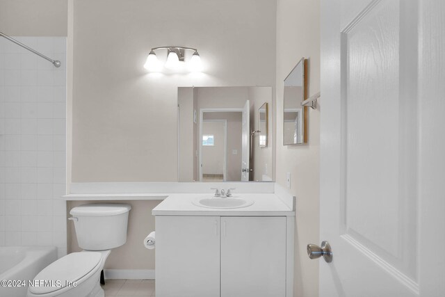 full bathroom featuring tiled shower / bath combo, vanity, tile patterned floors, and toilet